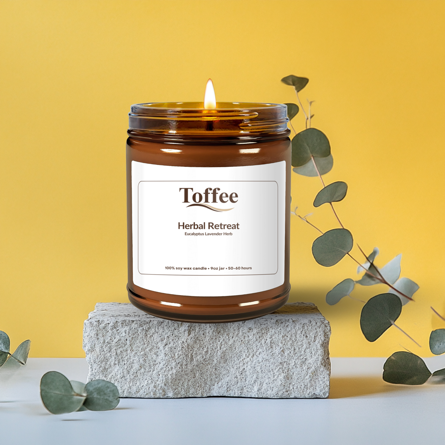 Candle labeled 'Toffee' from 'Herbal Retreat' on a stone block with a yellow background
