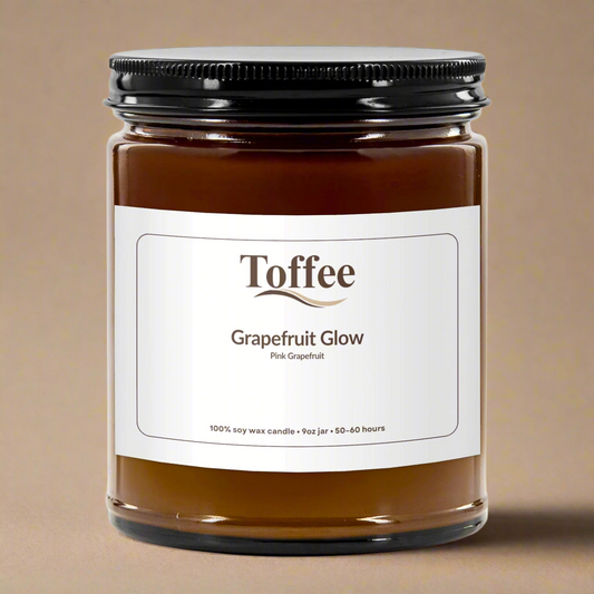 Jar of Toffee Grapefruit Glow candle with a white label on a white background