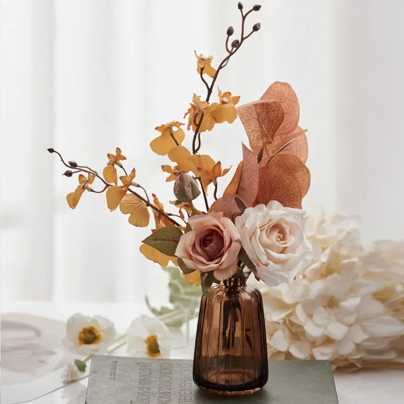 Decorative floral arrangement in a brown vase on a light surface with a blurred background